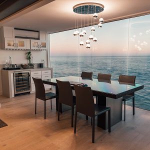 dining table set placed beside glass window